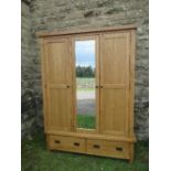 A modern oak mirror door wardrobe, width 59ins, depth 21ins, height 80ins, with British Design