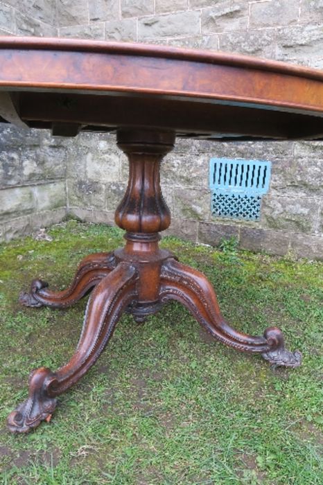 A 19th century burr walnut oval loo table, raised on a turned column, terminating in four outswept - Image 3 of 5