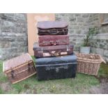 A collection of trunks, luggage, baskets, etc