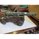 A model canon, on a wheeled wooden base