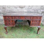 A Georgian style mahogany desk, raised on cabriole legs, width 51ins x depth 27ins x height 29ns