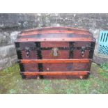 A domed top trunk, with metal and wooden bands, width 33ins x height 28ins