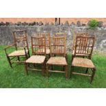 A set of seven (6 + 1), oak country style dining chairs, with spindle backs