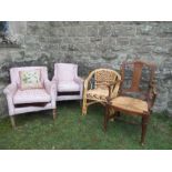 An oak framed armchair, a caned chair, and two similar upholstered chairs