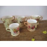 Five Royal Worcester miniature blush ivory mugs and loving cups, decorated with birds and flowers