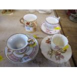 A Royal Worcester gilded ivory miniature cabinet cup and saucer, together with another cup and
