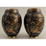 A pair of Carlton Ware vases, enamelled with a dragon and a tree, to a dark blue ground, height