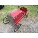 A red swing pedal car, made of wood, with solid rubber tyres, 33” x 18”