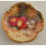 A Royal Worcester shaped dish, decorated with hand painted fruit to a mossy ground by Townsend, with