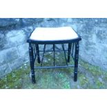 An ebonised Arts and Crafts style stool, raised on turned legs with spindle supports, width 17.75ins