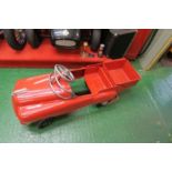 A red rotary pedal car, “pick up” style, possibly American,  48” x 16”