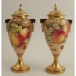 A pair of Royal Worcester covered vases, decorated all around with hand painted fruit, one signed