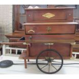 A Victorian style miniature musical organ grinder, with brass fittings, in working order, with extra