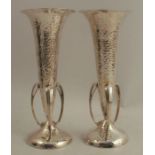A pair of Liberty & Co silver trumpet vases, with hammered finish, and scroll mounts to the base,