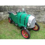 A green rotary pedal car, in the style of a Bentley “Supercharger”, with 2 seats, size 65” x 24”