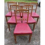 A set of six Edwardian oak dining chairs, with stuff over seats and carved decoration