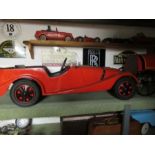 A Morgan pedal car, having swing pedals, and solid rubber tyres, approx. 48” x 18”