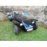 A black replica Lotus, approx. half scale, with electrical drive, size 70” x 37”