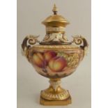 A Royal Worcester twin handled covered mask vase, decorated half round with hand painted fruit by