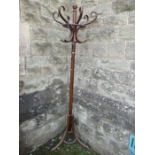 A bentwood coat stand, with six scrolling hooks and raised on a tripod base, height 78ins