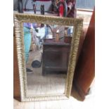 An antique moulded gilt framed wall mirror