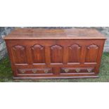 An Antique oak mule chest, with panelled front over two dummy drawers, 57ins x 20ins, height 29ins