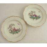 A pair of 19th century English porcelain dishes, the centres decorated with fabulous birds in