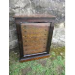 A miniature collector's or specimen chest, with rosewood effect glazed door, fitted with eight