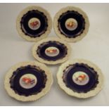 Five Royal Worcester plates, painted to the centre with fruit by Townsend, to a cobalt blue and