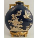 A Royal Worcester moon flask, the blue ground embossed in white and gilt flowers and bird, with gilt
