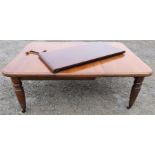 A Victorian mahogany wind out dining table, raised on turned legs, with two leaves, 50ins x 48ins,