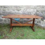 An Arts and Crafts Cotswold School oak refectory table, with trestle style ends and sledge feet,