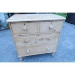A pine chest, of two short over two long drawers, raised on turned legs, width 33ins x depth 18.5ins