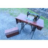 A treadle sewing machine table, with a boxed Singer sewing machine, serial number S814925,