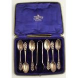 A cased set of six silver tea spoons, with pierced decoration, together with matching sugar tongs (