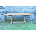 An oak rectangular adzed top dining table, raised on octagonal shaped baluster columns, with