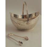 A silver basket, of oval form, with gadrooned lower body and swing handle, Chester 1907, weight 3oz,