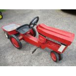 A rotary pedal  “International” tractor and trailer, with solid rubber tyres, Tractor approx. 36”