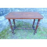 A late Victorian mahogany centre table, of rectangular form, with canted corners, raised on turned