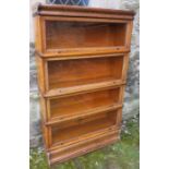 An oak four tier Wernicke System "Elastic" bookcase, with glazed fronts, width 34ins x height