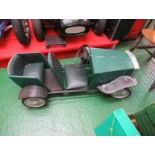 A green two seater swing pedal model car, with solid rubber tyres, approx. 48” x 18”, possibly