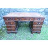 A twin pedestal desk, width 53.5ins x depth 26.5ins x height 30ins