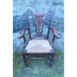 A Georgian elm armchair, with pierced vase lattice splat back, and rush seat