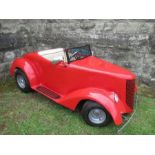 A red petrol driven Hot Rod replica car, with pneumatic tyres, and a fibre glass body, 80” x36”