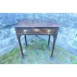 An 18th century side table, fitted with a frieze drawer, raised on turned legs terminating in pad