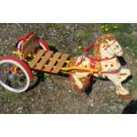 A Mobo rotary pedal horse and cart, in yellow and red, with wooden seat, and solid rubber tyres, 40”