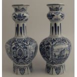 A pair of 20th century Delft blue and white vases, decorated with landscapes, height 10.5ins -