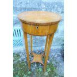 An Edwardian satinwood lady's work table, the circular cross banded top opening to reveal slide
