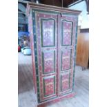 A painted wardrobe, with heraldic decorations width 36ins, depth 26ins, height 79ins