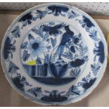 An Antique Delft circular dish, decorated in blue and white with a bird and foliage, diameter 12ins